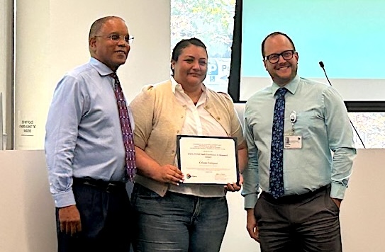 Celeste Enriquez accepts the Department of Medicine Staff Excellence Award from Neil Powe. 